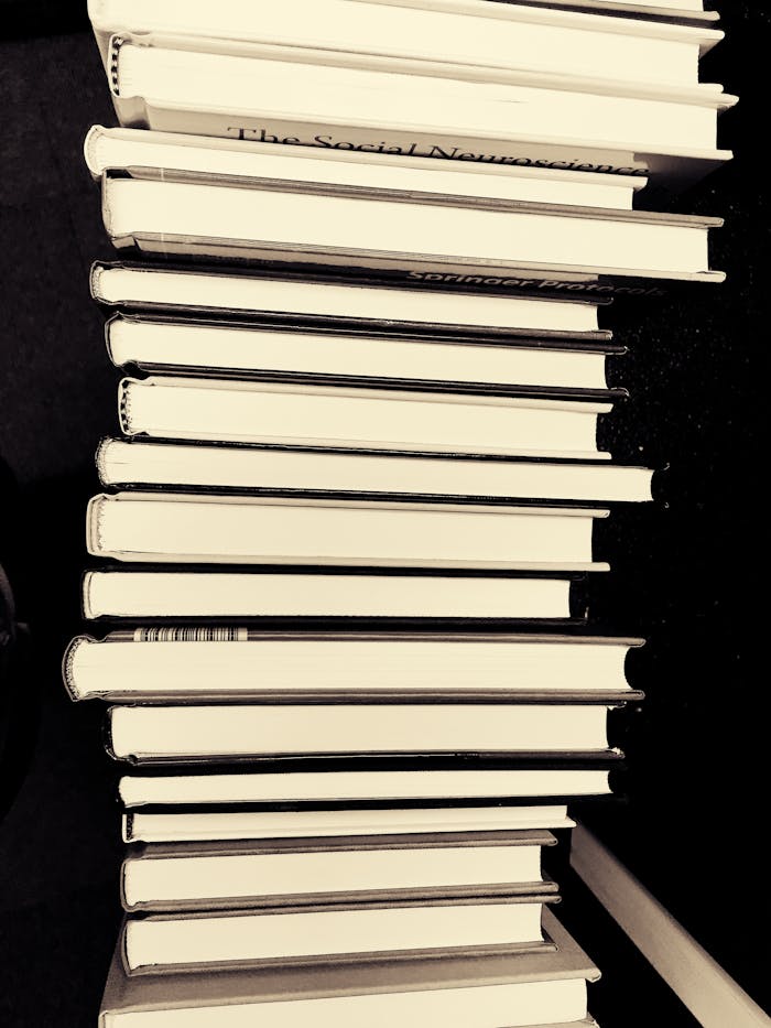 Monochrome image of a stack of books in a library for educational study.